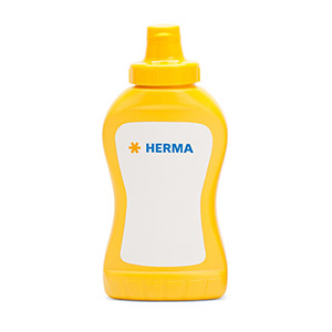 Yellow mustard bottle with a white label that has the word 'HERMA' written in blue.