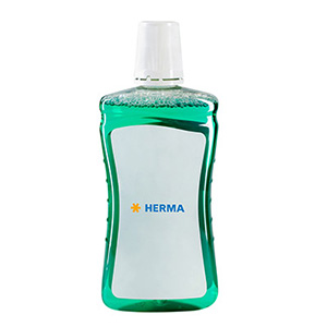 Green liquid in a transparent bottle with a white label that says 'HERMA'.