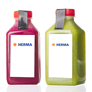 Two bottles of juice, one red and one green, both with a white label that says 'HERMA'.