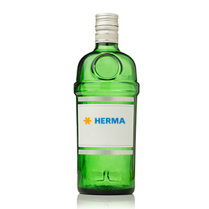 Green glass bottle with a white label that says 'HERMA' in blue lettering.