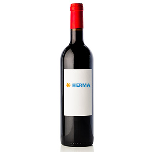 A bottle of red wine with a red cork and a white label that has the word 'HERMA' written in blue letters.