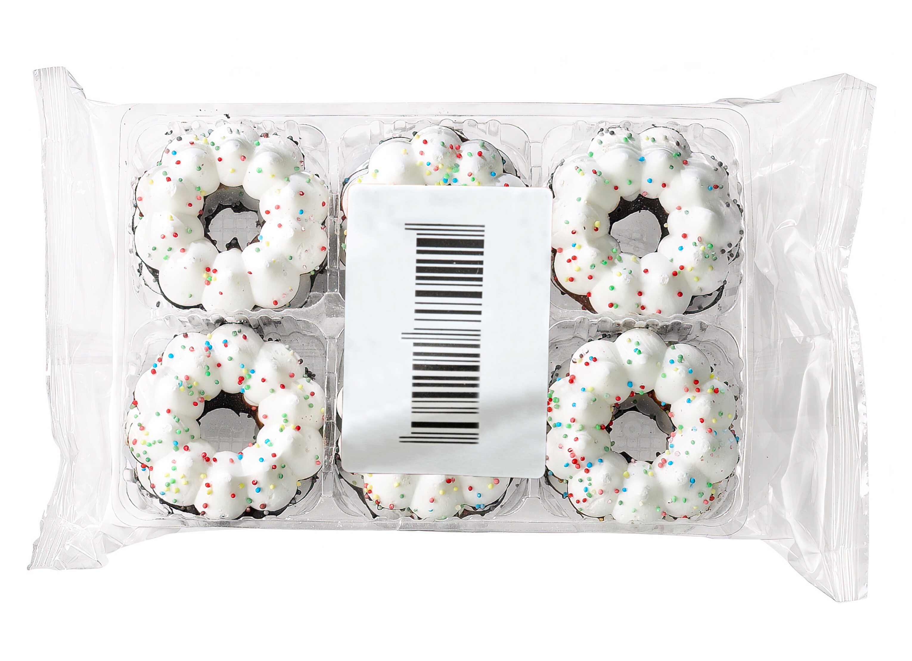 Six little donuts with white icing and colorful sprinkles in a clear packaging.