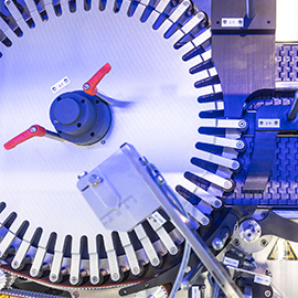 Machine with rotating parts and control mechanisms designed for industrial applications. Visible controls and sensors.
