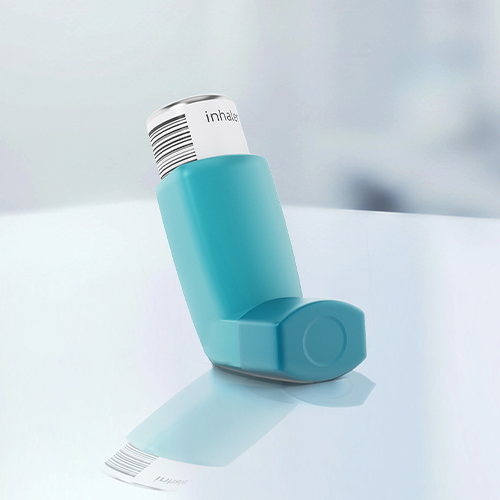 A blue asthma inhaler is sitting on a reflective surface.