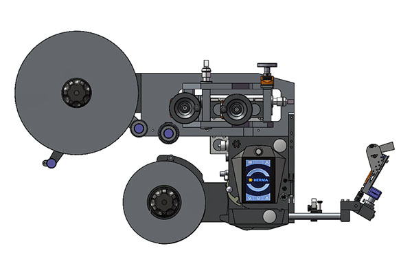 Technical drawing of a labeling machine with two large reels, a conveyor mechanism, and control elements.
