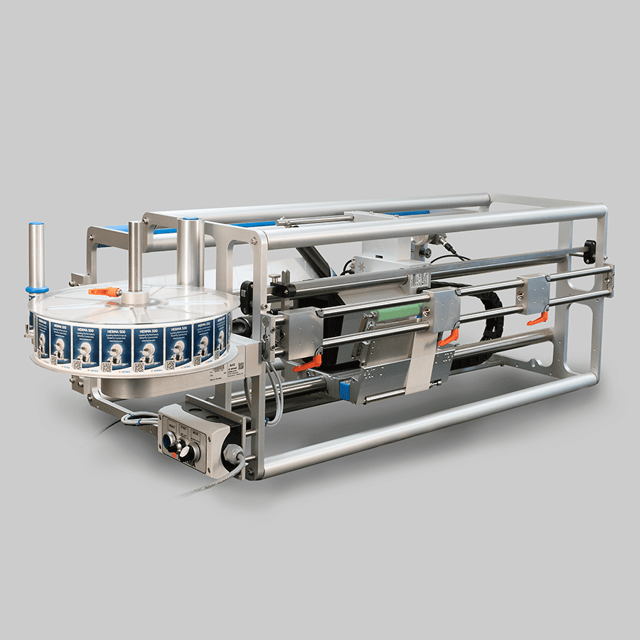 Labeling machine with a rotating disc and mechanical components, designed for industrial use.