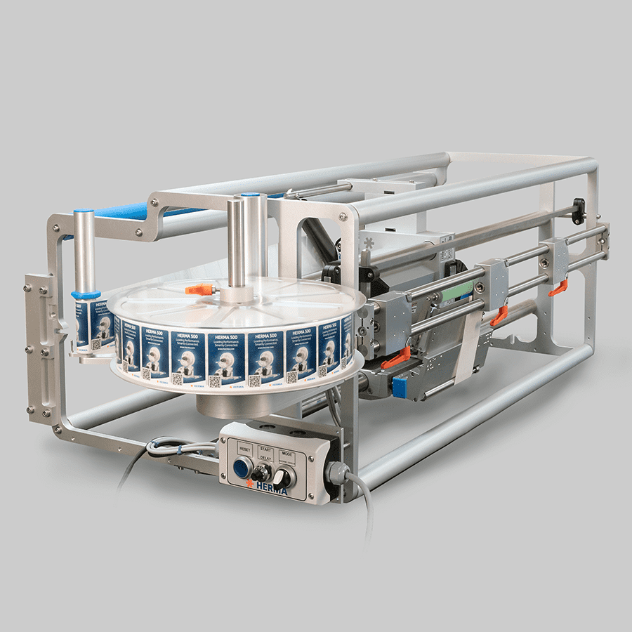 A mechanical device with a rotating table equipped with labels and a control panel for operation.