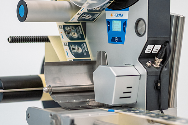 Labeling machine with a digital display and continuous label feed. The machine is designed for labeling products.