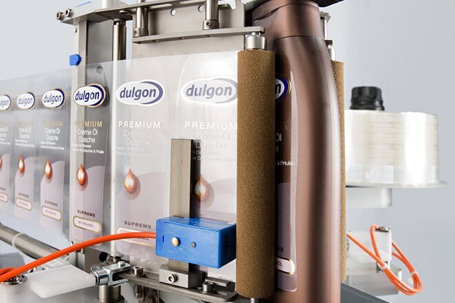 An industrial filling machine with multiple containers used for filling liquids into bottles or cans.