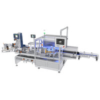 Automated packaging machine with multiple stations, screens, and conveyor belts for processing bottles or containers.