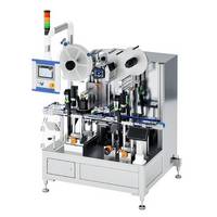 Automatic labeling machine with two rollers, control unit, and multiple bottles on a conveyor belt.