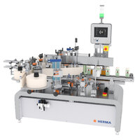 Automatic labeling machine with multiple stations, equipped with a control panel and various holders for bottles and labels.