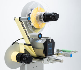 Labeling machine with two rollers, a control unit, and a display for adjusting the settings.