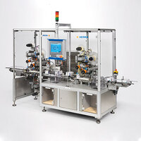 Automatic packaging machine with multiple stations, equipped with a control panel and various mechanical components for processing products.