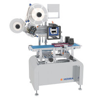 Labeling machine with rollers, control panel, and conveyor belt, manufactured by HERMA. Ideal for industrial applications.